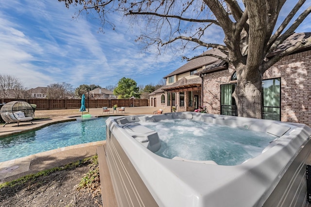 view of pool featuring an outdoor living space, a fenced backyard, a patio, and a hot tub