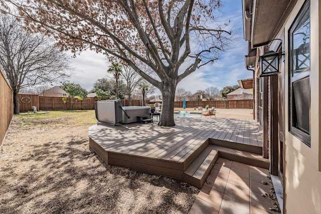 wooden terrace featuring a hot tub, a fenced in pool, and a fenced backyard