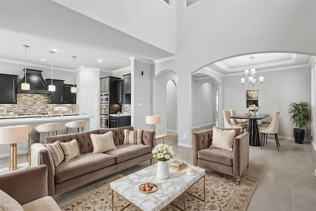 living area with crown molding, arched walkways, and recessed lighting