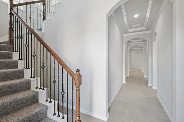 stairs featuring arched walkways, recessed lighting, ornamental molding, baseboards, and tile patterned floors