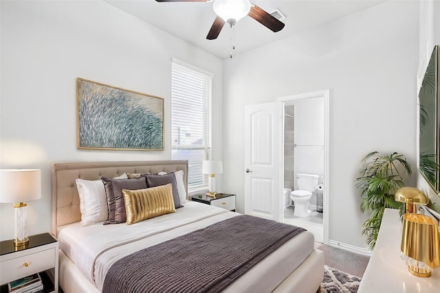 carpeted bedroom with baseboards, ensuite bathroom, and ceiling fan