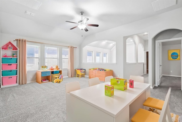 recreation room with carpet floors, ceiling fan, visible vents, and vaulted ceiling