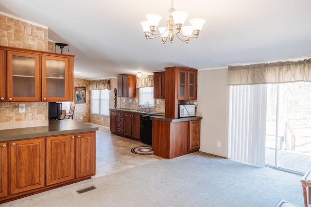 kitchen featuring white microwave, visible vents, dishwasher, brown cabinetry, and dark countertops