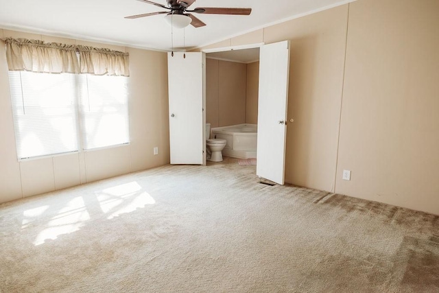 unfurnished bedroom with connected bathroom and carpet flooring