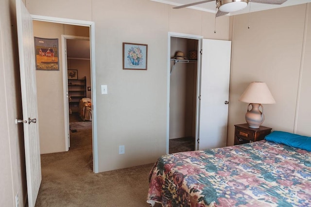 carpeted bedroom with a ceiling fan and a closet