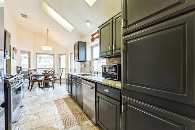 kitchen featuring a toaster, a sink, visible vents, vaulted ceiling, and appliances with stainless steel finishes