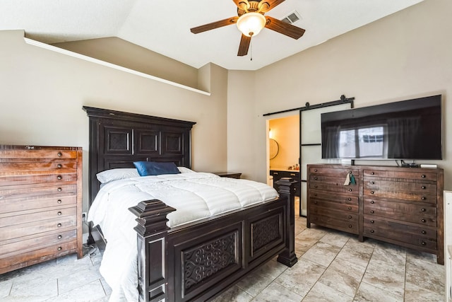 bedroom with visible vents, a barn door, ensuite bathroom, ceiling fan, and vaulted ceiling