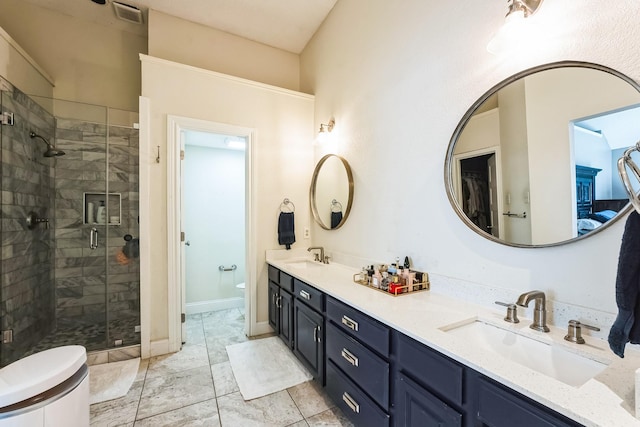 bathroom with toilet, a shower stall, visible vents, and a sink