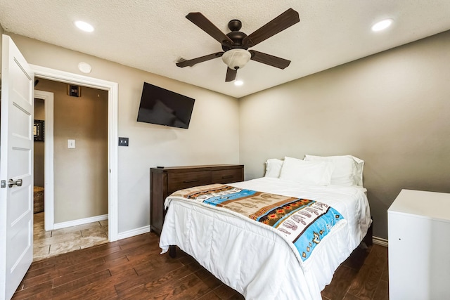 bedroom featuring a textured ceiling, recessed lighting, wood finished floors, a ceiling fan, and baseboards