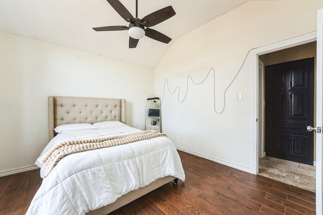 bedroom with ceiling fan, vaulted ceiling, baseboards, and wood finished floors