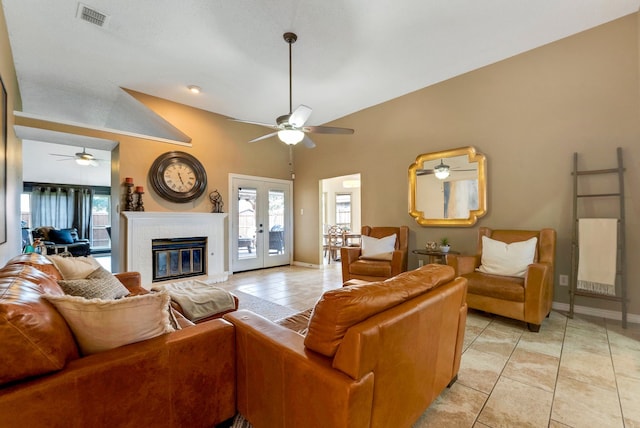 living area with light tile patterned floors, visible vents, baseboards, french doors, and a brick fireplace