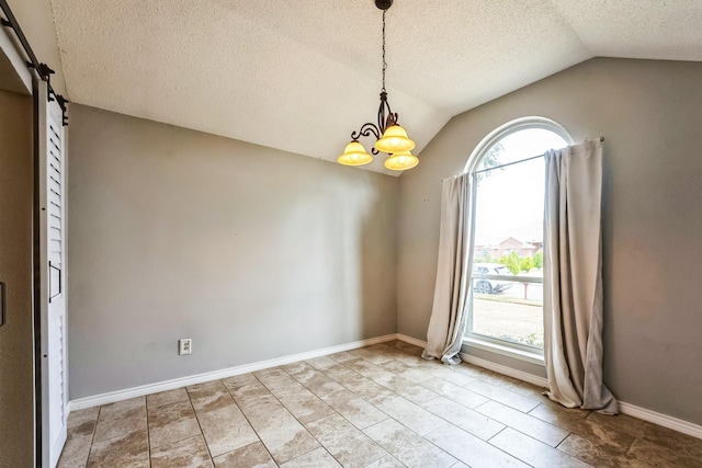 empty room with lofted ceiling, a notable chandelier, plenty of natural light, and baseboards