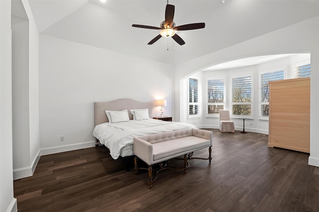 bedroom with dark wood finished floors, a ceiling fan, and baseboards