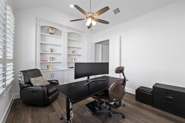 home office featuring dark wood-style floors, lofted ceiling, visible vents, a ceiling fan, and baseboards