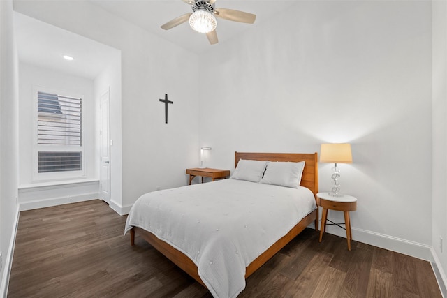 bedroom featuring wood finished floors, a ceiling fan, and baseboards