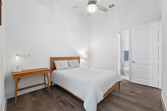 bedroom featuring baseboards, visible vents, dark wood finished floors, and connected bathroom