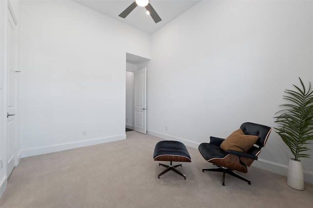 sitting room with high vaulted ceiling, ceiling fan, baseboards, and light colored carpet