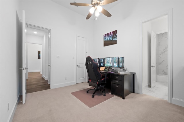 home office with marble finish floor, carpet, baseboards, and a ceiling fan