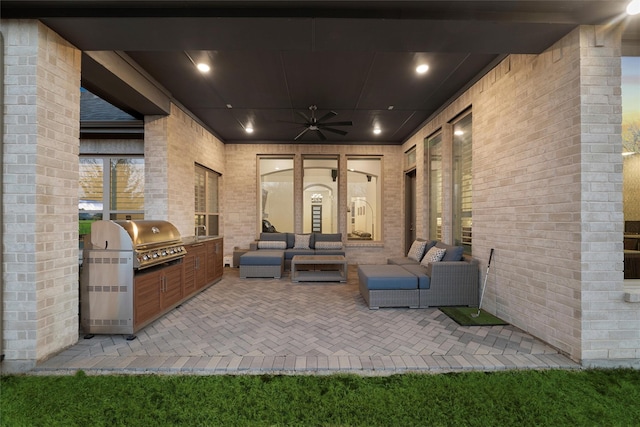 view of patio with ceiling fan, an outdoor kitchen, outdoor lounge area, and area for grilling