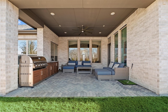 view of patio / terrace featuring an outdoor hangout area, ceiling fan, area for grilling, and a sink