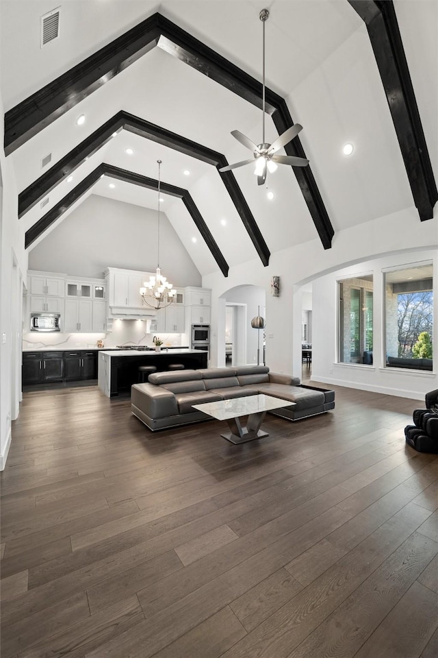 rec room featuring visible vents, dark wood-type flooring, high vaulted ceiling, beamed ceiling, and ceiling fan with notable chandelier