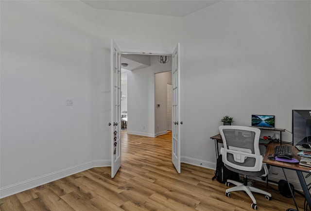 home office with light wood-type flooring and baseboards