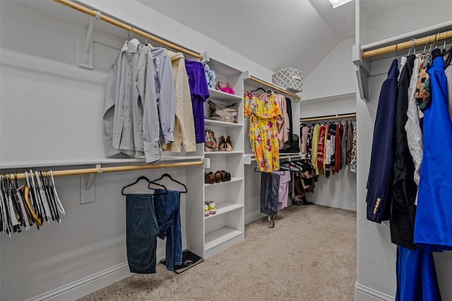 walk in closet featuring lofted ceiling and carpet