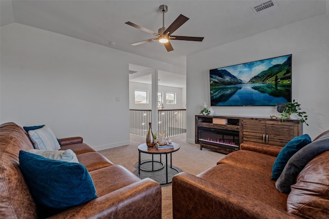 living area featuring visible vents, light carpet, vaulted ceiling, ceiling fan, and baseboards