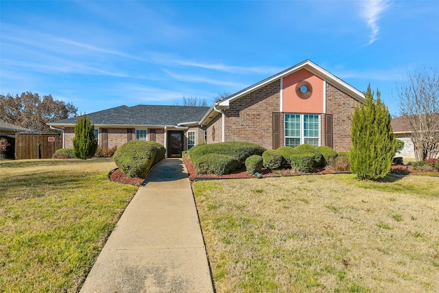 view of front of home featuring a front lawn and brick siding