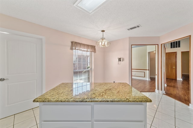 kitchen with light tile patterned floors, visible vents, and a notable chandelier