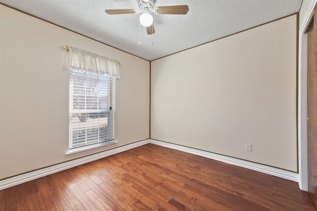 unfurnished room featuring ceiling fan, a textured ceiling, baseboards, and wood finished floors