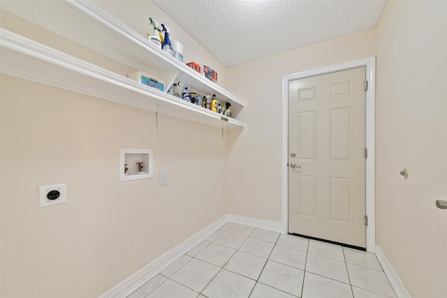 laundry room with light tile patterned floors, a textured ceiling, laundry area, washer hookup, and electric dryer hookup