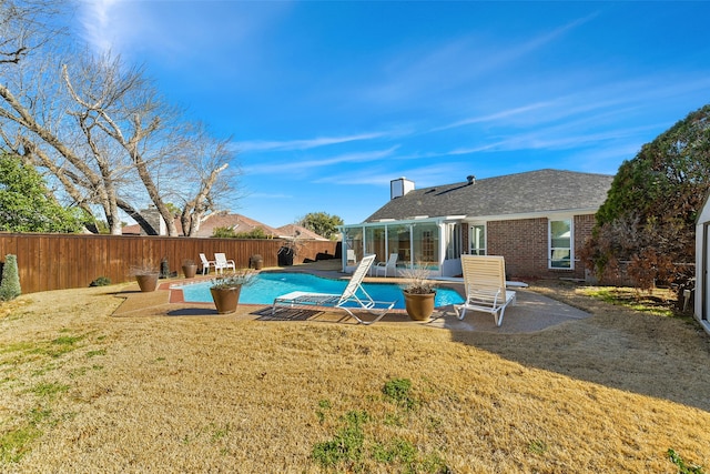 view of swimming pool with a yard, a patio area, a fenced backyard, and a fenced in pool