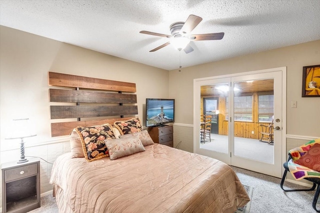 carpeted bedroom with a ceiling fan and a textured ceiling