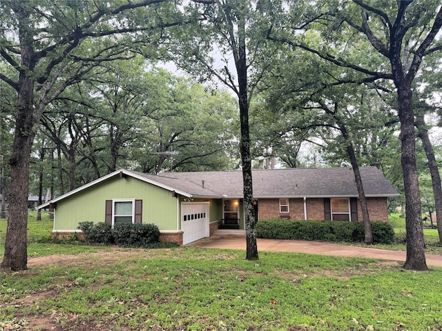 single story home with concrete driveway, brick siding, a front lawn, and an attached garage