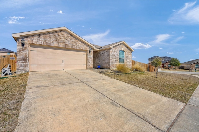 single story home with driveway, brick siding, an attached garage, and fence