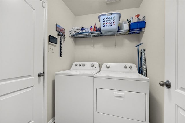 washroom featuring laundry area and washer and clothes dryer