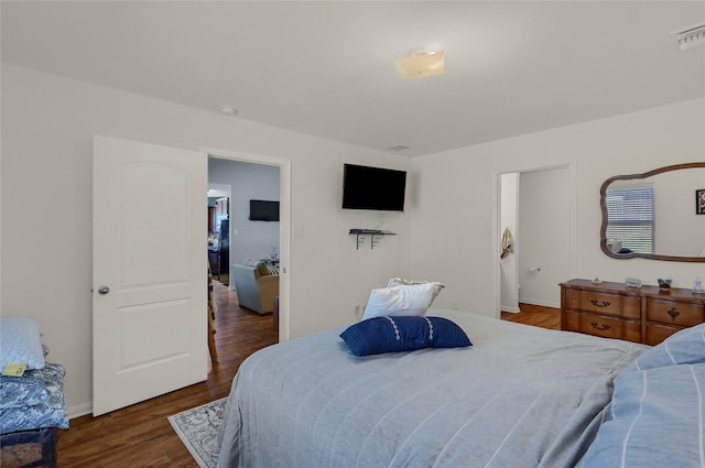 bedroom with visible vents and wood finished floors