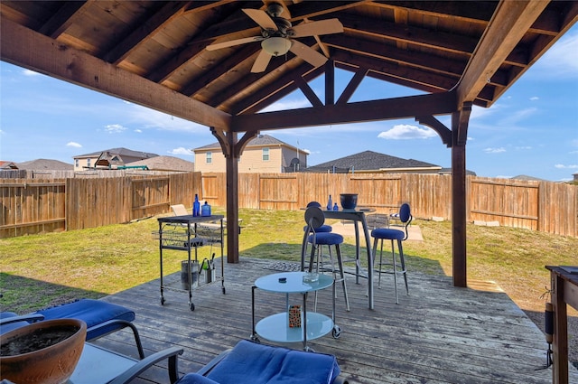 exterior space with a fenced backyard, ceiling fan, and a deck