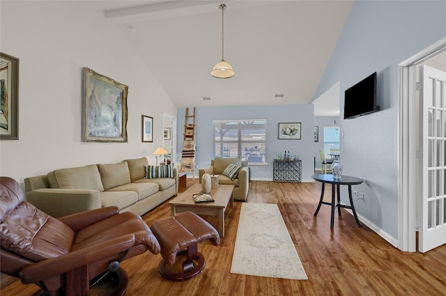 living room with baseboards, visible vents, high vaulted ceiling, and wood finished floors