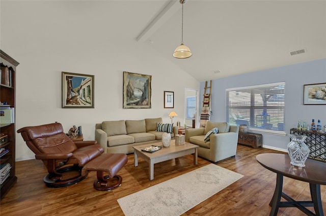 living room with baseboards, visible vents, wood finished floors, high vaulted ceiling, and beam ceiling