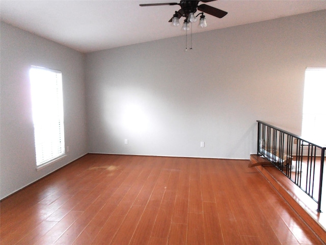 unfurnished room with wood finished floors and a ceiling fan