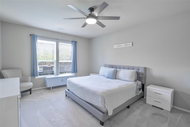 bedroom with baseboards, visible vents, a ceiling fan, and light colored carpet