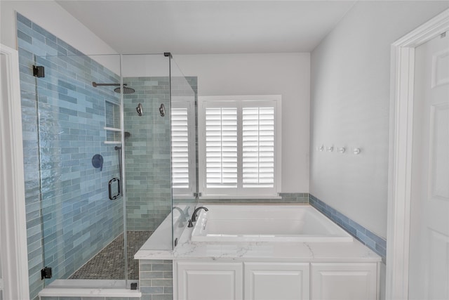 full bathroom featuring a shower stall and a bath