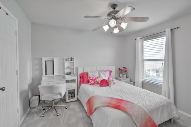 bedroom with ceiling fan, carpet floors, and baseboards