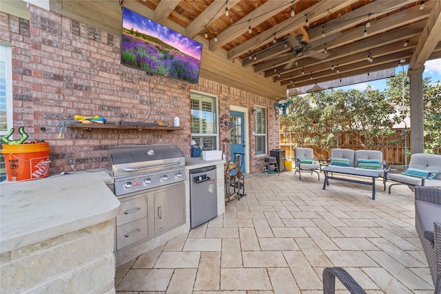 view of patio featuring fence, grilling area, an outdoor kitchen, and an outdoor hangout area