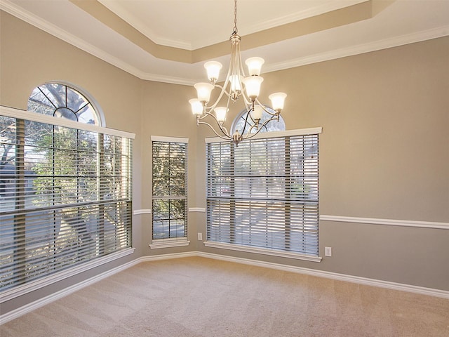 interior space featuring ornamental molding, a raised ceiling, and a notable chandelier