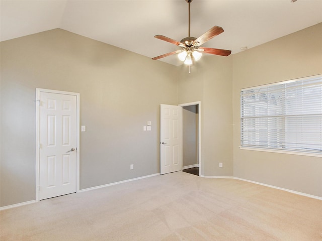 unfurnished room with light carpet, a ceiling fan, and baseboards