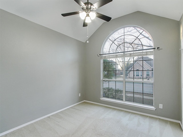 unfurnished room with carpet floors, baseboards, a ceiling fan, and lofted ceiling