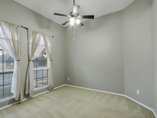 spare room featuring carpet floors, ceiling fan, and baseboards